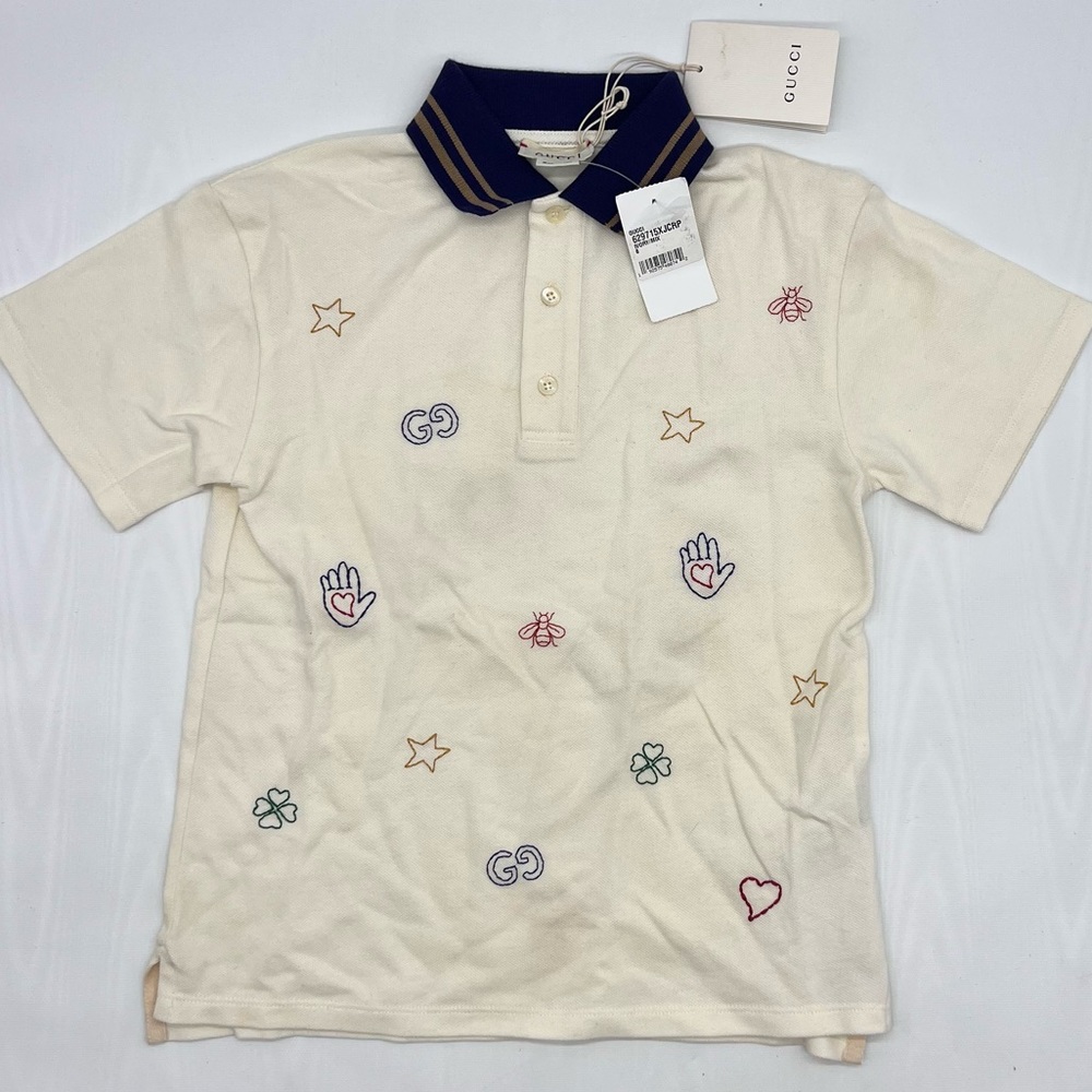 GUCCI EMBROIDERED ALLOVER LOGO POLO
CREAM